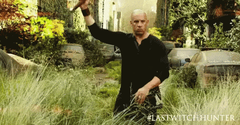 a man in a black shirt is holding a sword in a field with #lastwitchhunter written in the corner