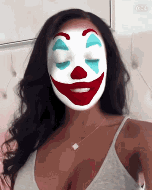 a woman with a clown face on her face with the time of 4:04