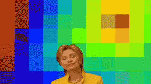 hillary clinton stands in front of a colorful background