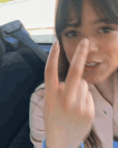 a woman is making a middle finger gesture