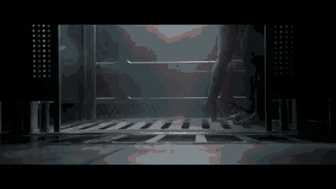 a person standing in a dark room with their feet in the water
