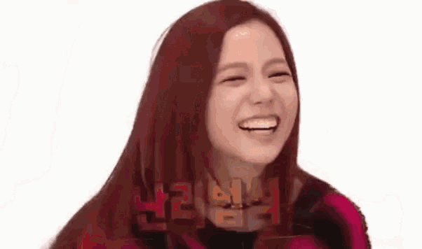 a woman with red hair is laughing with her eyes closed on a white background .