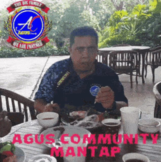 a man sits at a table with a plate of food and the words agus community mantap