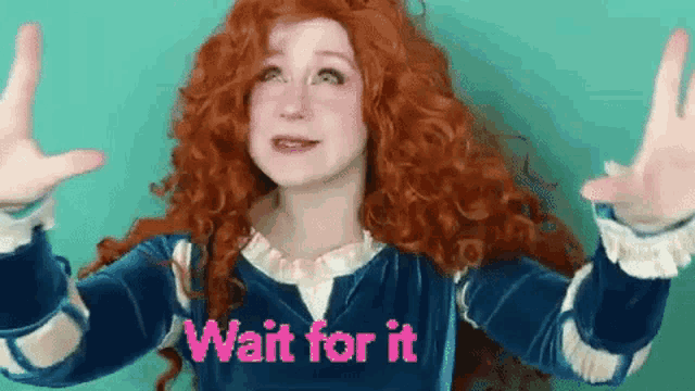a woman with red hair is wearing a blue dress and a wig and is holding her hands up .