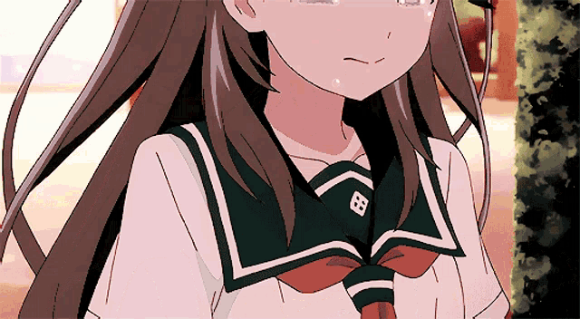 a girl with long brown hair is wearing a green sailor uniform