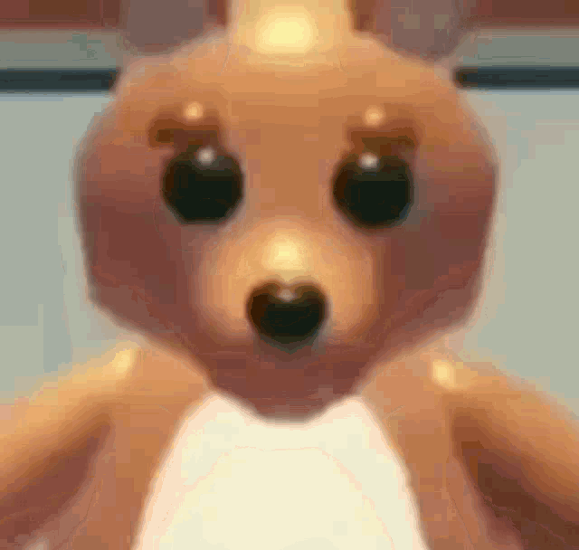 a close up of a stuffed animal that looks like a kangaroo with big eyes .