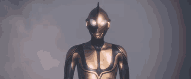 a statue of a man in a black and gold superhero costume