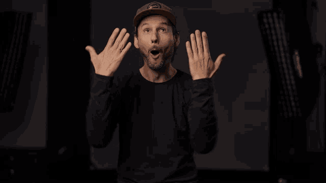 a man wearing a black shirt and a hat with a sticker that says ' abercrombie & fitch '