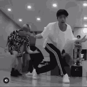a group of young men are dancing together in a room .