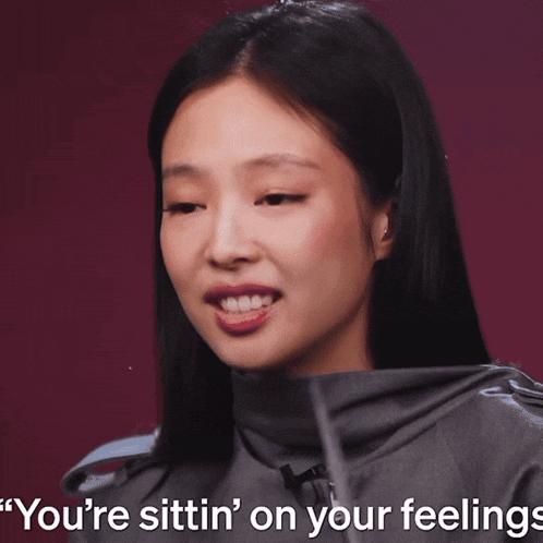 a close up of a woman with the words you 're sittin ' on your feelings behind her