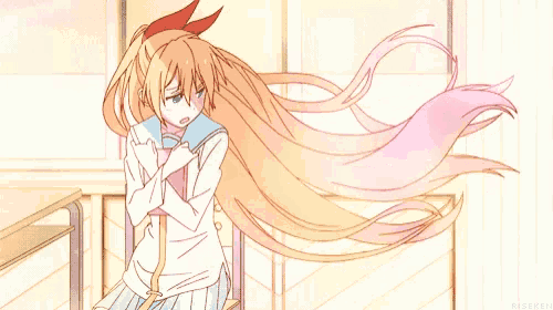 a girl with long blonde hair is sitting in a chair with her arms crossed