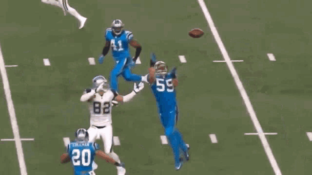 a football player with the number 5 on his jersey runs with the ball