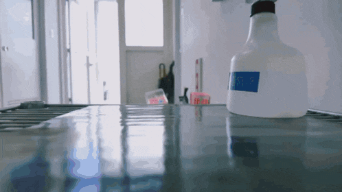 a white spray bottle with a blue label that says ' cleaning '