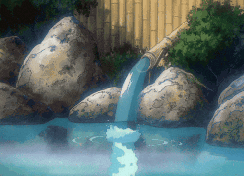 a stream of water is coming out of a bamboo pipe