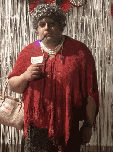 a woman in a red dress with a name tag that says edna