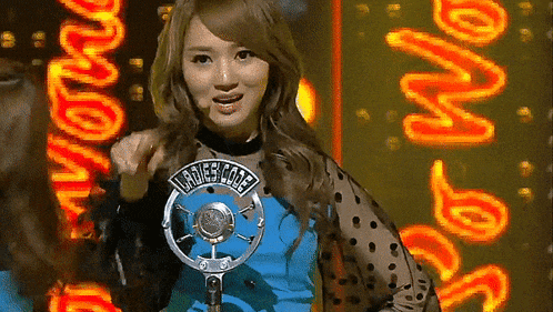 a woman stands in front of a microphone with ladies cole written on her shirt