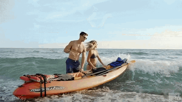a man and a woman in a kayak that says mehoutwo on it
