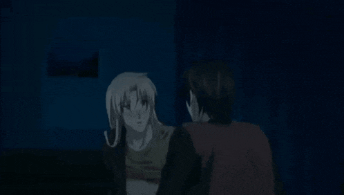 a man and a woman are kissing in the dark in a dark room .