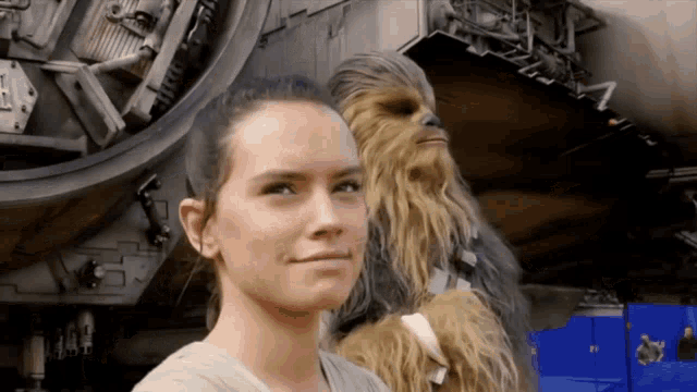 a woman and a chewbacca are posing for a picture together