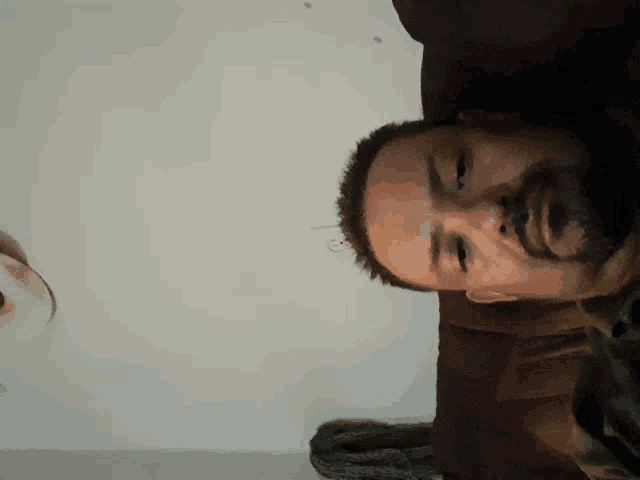 a man with a beard is sitting on a couch