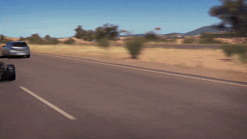 a car is driving down a desert road