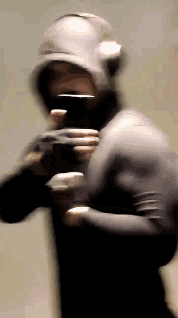 a blurry picture of a person wearing a hooded jacket
