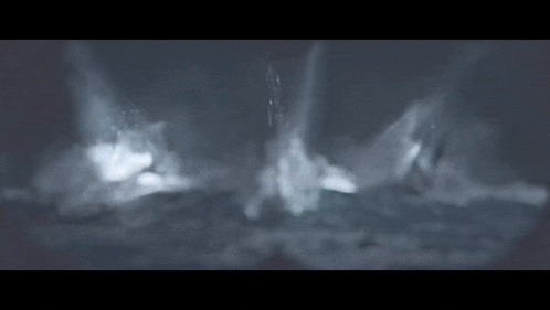 a boat is floating on top of a large body of water in the dark .