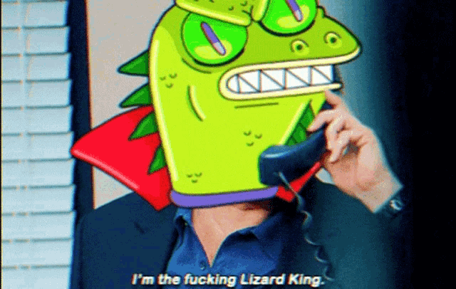 a man with a lizard mask on his head talking on a phone