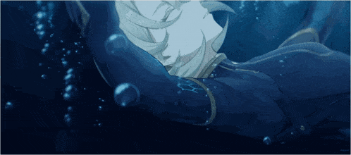 a person is floating in the water with bubbles surrounding them
