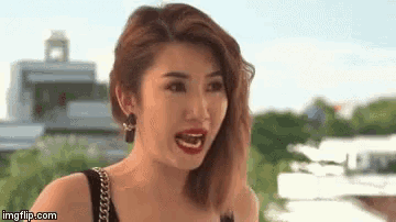 a woman with red lipstick and black earrings is smiling with imgflip.com in the corner