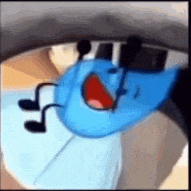 a blue cartoon character is laying on a bed with his mouth open and feet sticking out .