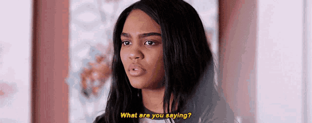 a woman is asking what are you saying in front of a painting .