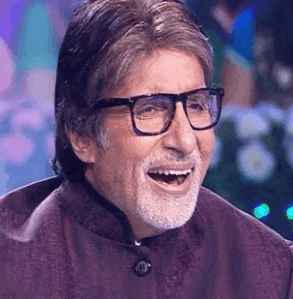 a man wearing glasses and a beard is smiling .