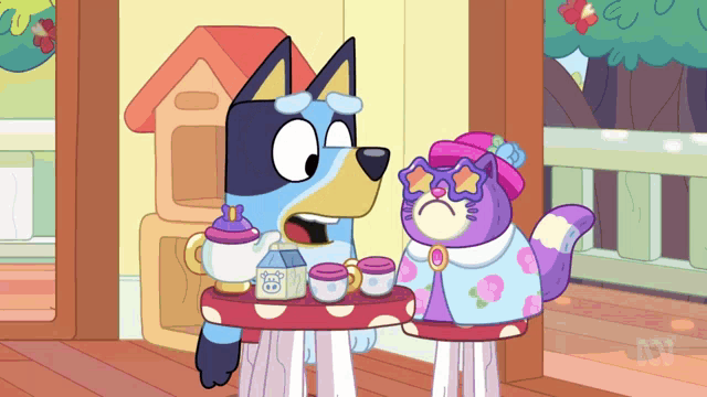 a dog and a cat are sitting at a table with a tea set