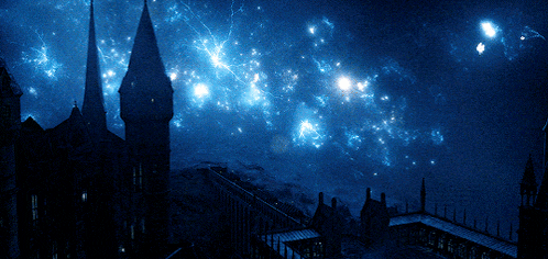a night sky with a castle in the foreground and stars in the background