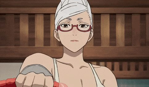 a woman with glasses and a towel on her head is holding something in her hand .