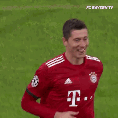 a soccer player wearing a red jersey with the number 32 on the back