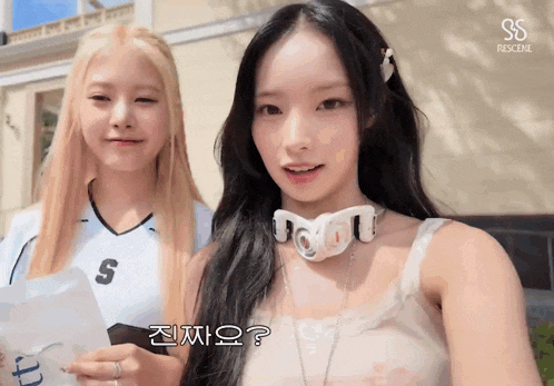 two girls are standing next to each other and one has a letter s on her jersey