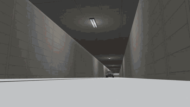 a car is parked in a tunnel with a light on the ceiling