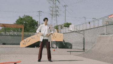 a person standing in a skate park with a blue circle around their head that says ' supreme ' on it
