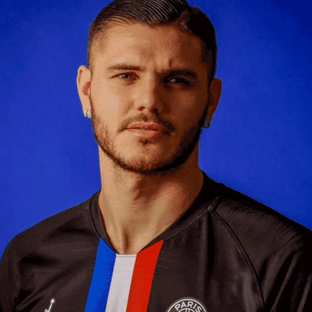 a man with a beard wears a black shirt with the word paris on it