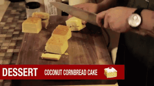 a man is cutting a piece of coconut cornbread cake