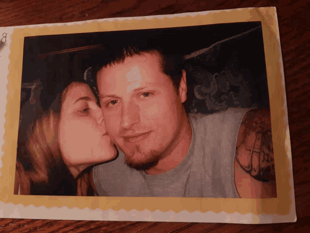 a woman kisses a man on the cheek in a photo with the number 8 on it