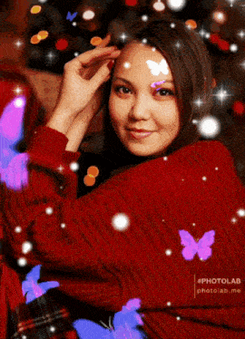 a woman in a red sweater is surrounded by butterflies and the letter b