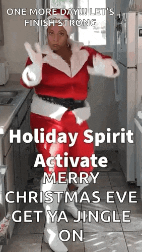 a woman dressed as santa claus is dancing in a kitchen with a christmas message .