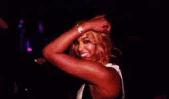 a woman with red sleeves is dancing in a dark room