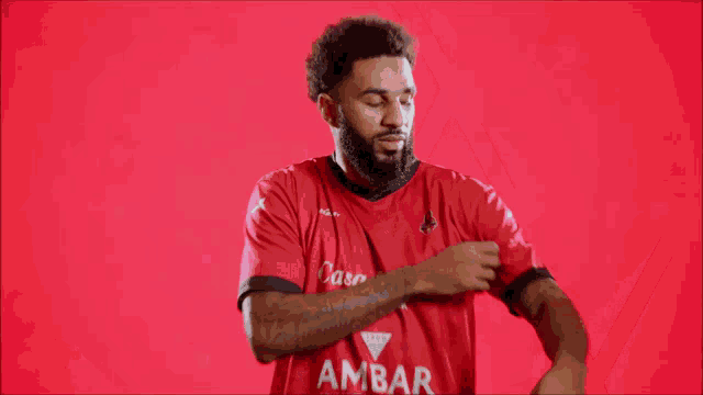 a blurry picture of a man in a red shirt dancing .
