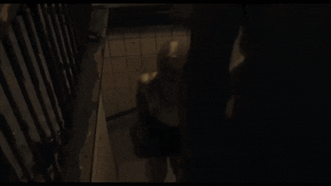 a person standing in a dark room with a shadow on their face