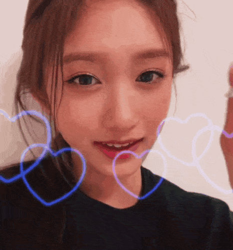 a close up of a woman 's face with hearts around her