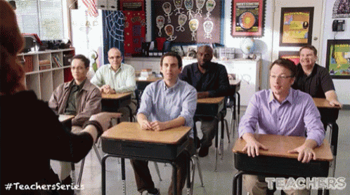 a group of men are sitting at desks in a classroom with teachers series written on the bottom of the screen